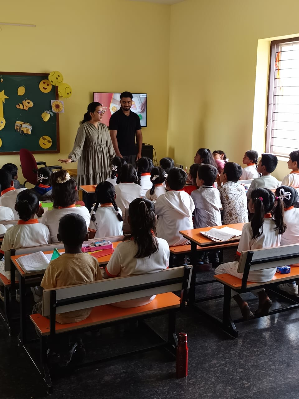 School students raising their hands during a classroom session